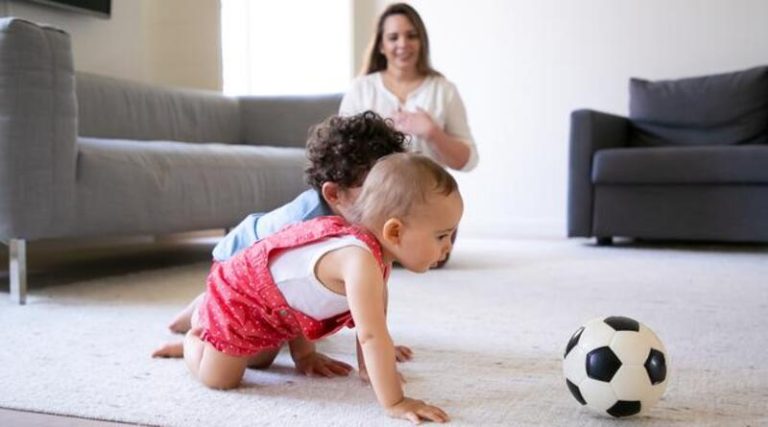 070893400_1661833876-cute-little-kids-crawling-carpet-playing-with-soccer-ball-caring-mother-sitting-floor-smiling-watching-children-selective-focus-family-indoors-weekend-childhood-concept (1)