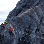 A climber on the rope bridge near the summit.